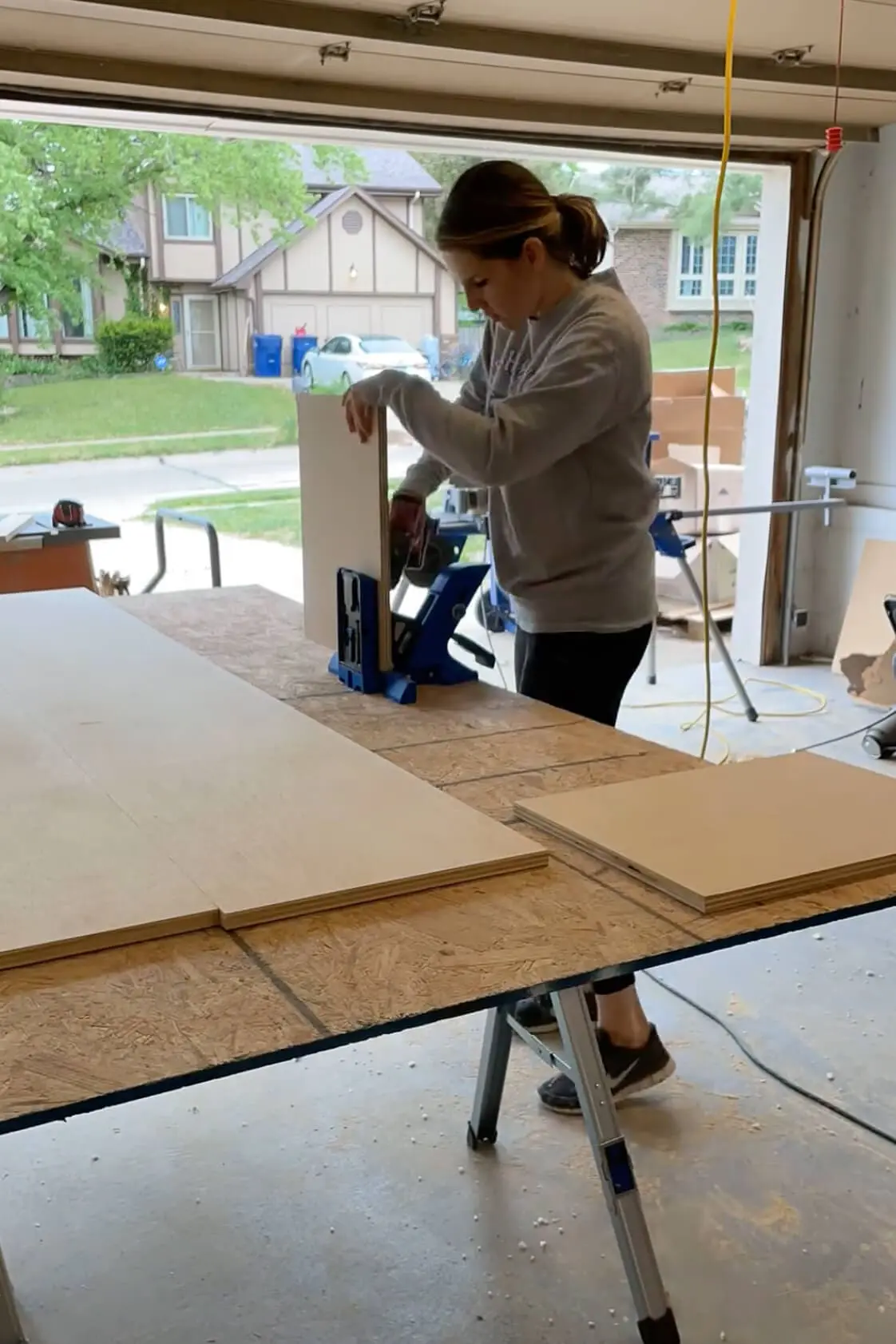 Using a Kreg jig to make pocket holes for DIY pantry shelves.